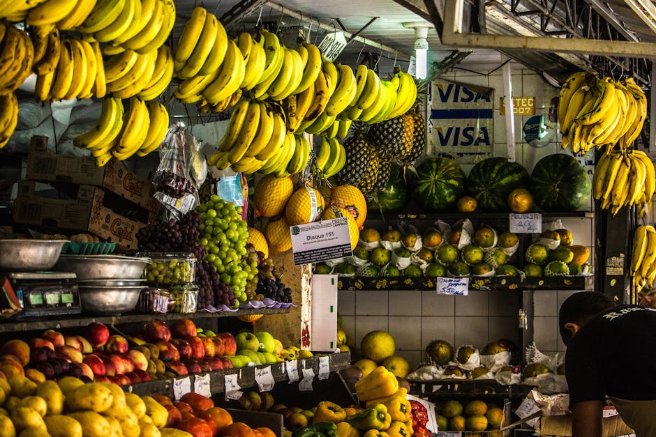 pexels-photo-796580-796580 Vibrant fruit stall in an urban market featuring bananas, apples, and more.